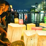 People release paper lanterns on the Motoyasu river facing the gutted Atomic Bomb Dome in remembrance of atomic bomb victims on the 69th anniversary of the bombing of Hiroshima